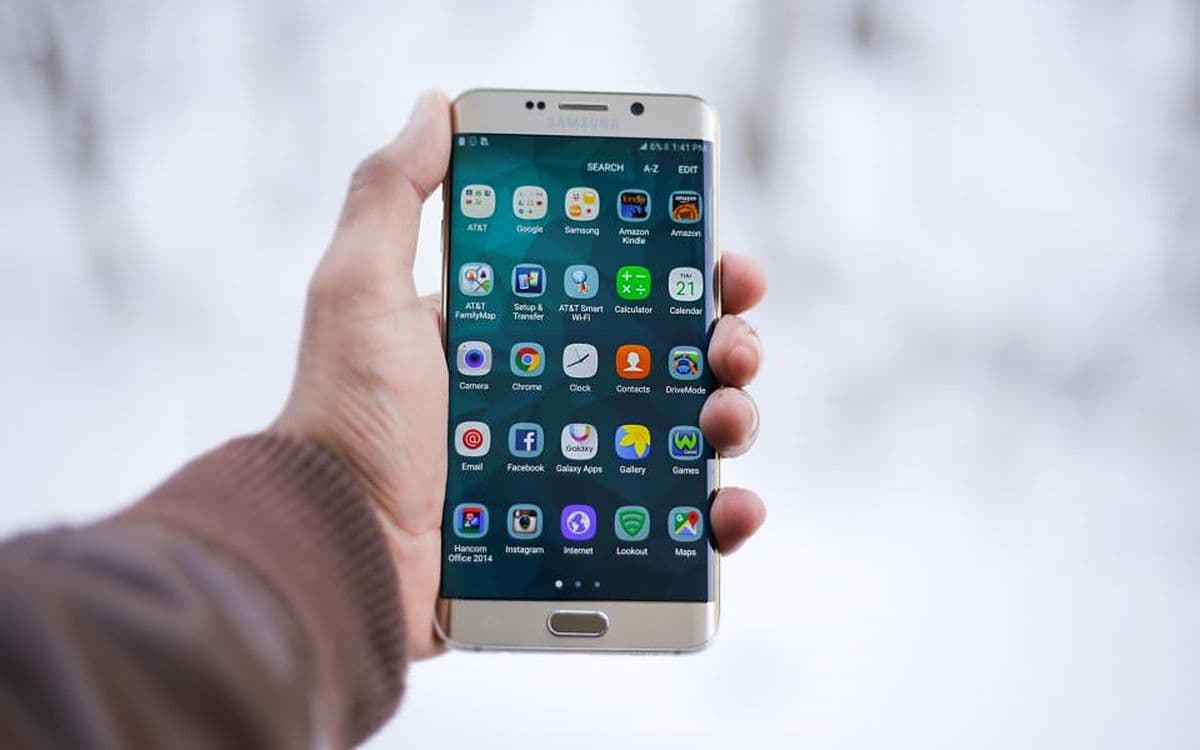 A hand holding an Android phone.