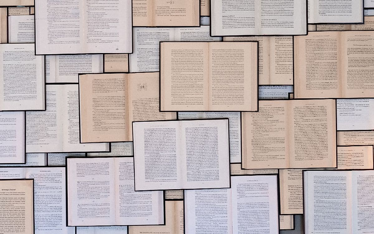 Dozens of open book pages laid out edge to edge.
